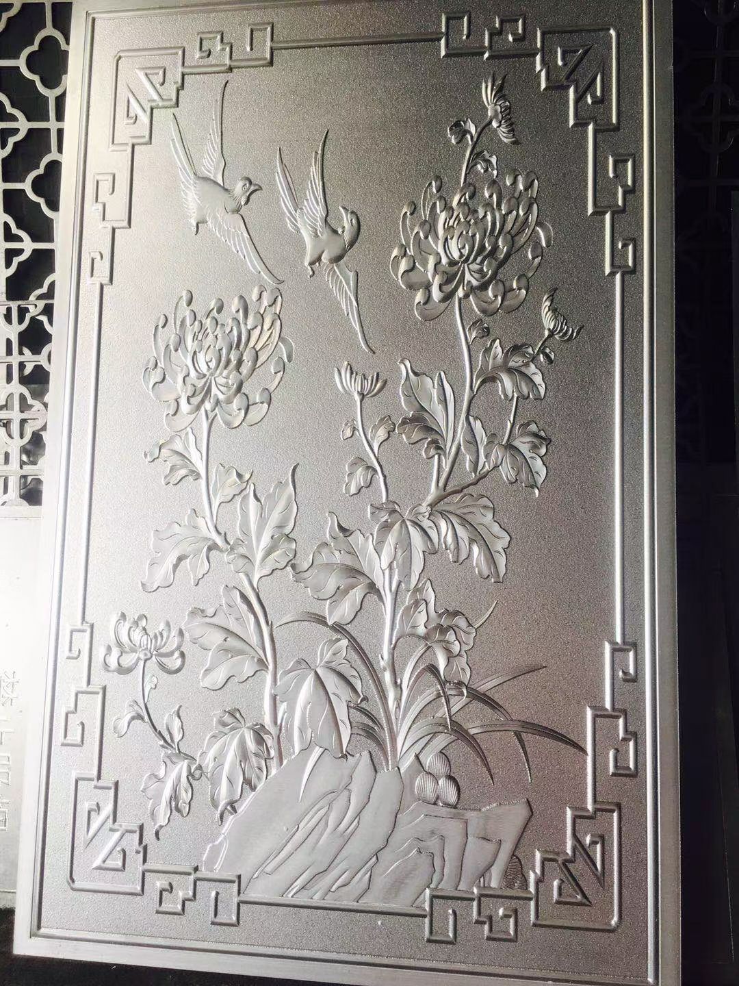 Physical metal relief door panel with a bamboo-leaf pattern