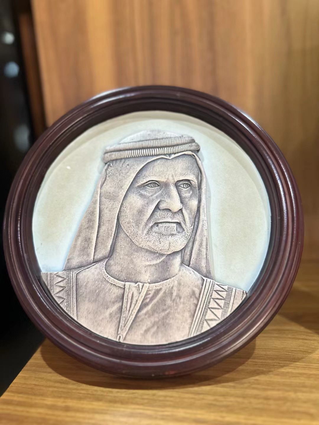 Physical portrait-themed metal relief plaque