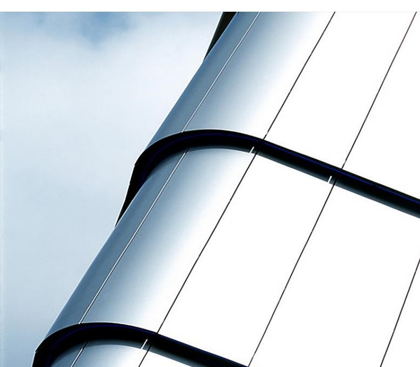 Curved façade made with roller-coated aluminum solid panels